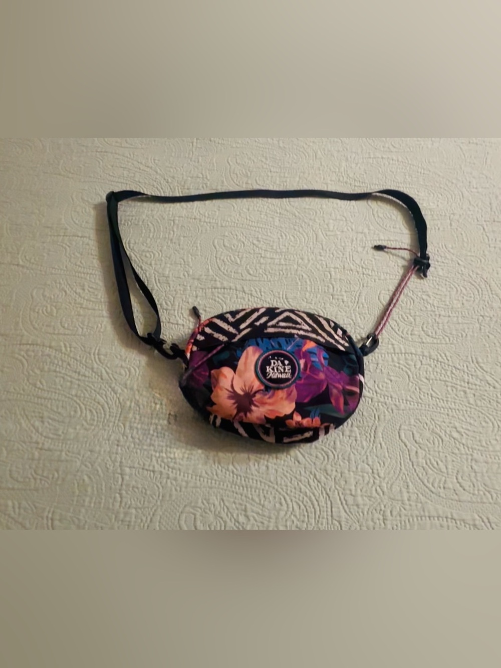 DaKine Joey crossbody bag, floral design, adjust straps, gently used.